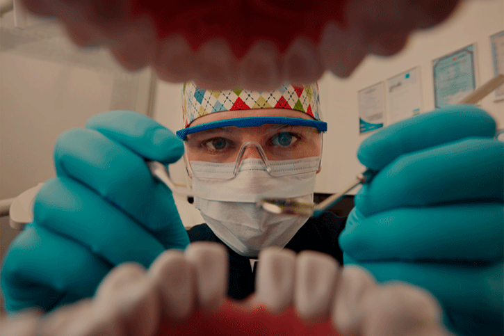 A photograph capturing a dentist performing a thorough oral examination during a dental check-up.