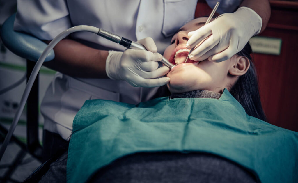 Oral Surgery Dentist Treating a Patient's Teeth